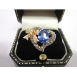 A SAPPHIRE AND DIAMOND 18CT WHITE GOLD DRESS RING the oval cut sapphire within a heart motif with