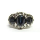 A SAPPHIRE AND DIAMOND TRIPLE CLUSTER RING unmarked, the three oval cuts enclosed by twenty single