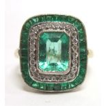 AN EMERALD AND DIAMOND 18 CARAT GOLD PANEL RING the step cut emerald, 7.4mm by 5.5mm by 4mm deep,