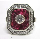 A DIAMOND AND CALIBRE RUBY PANEL RING  the white mount stamped '750', the central brilliant cut of