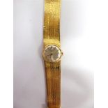 LONGINES, A LADYS 9 CARAT GOLD BRACELET WATCH the circular white dial with gilt batons and hands,