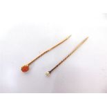 A CORAL STICKPIN and a pearl (untested & unwarranted) stickpin