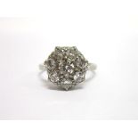 A EIGHT STONE DIAMOND CLUSTER RING the white mount stamped '18ct' and 'Plat' the central brilliant