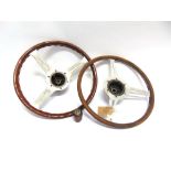 TWO WOOD RIMMED STEERING WHEELS with aluminium centres, approximately 39.5cm and 38cm diameter