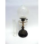A VICTORIAN OIL LAMP with clear facetted glass reservoir on metal and ceramic base, together with
