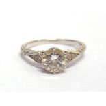 A DIAMOND SINGLE STONE RING the brilliant cut approximately 1.06cts calculated, with a trio of small