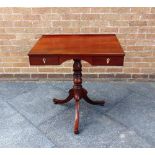 A MAHOGANY OCCASSIONAL TABLE fitted with two drawers raised on turned pedestal with outswept