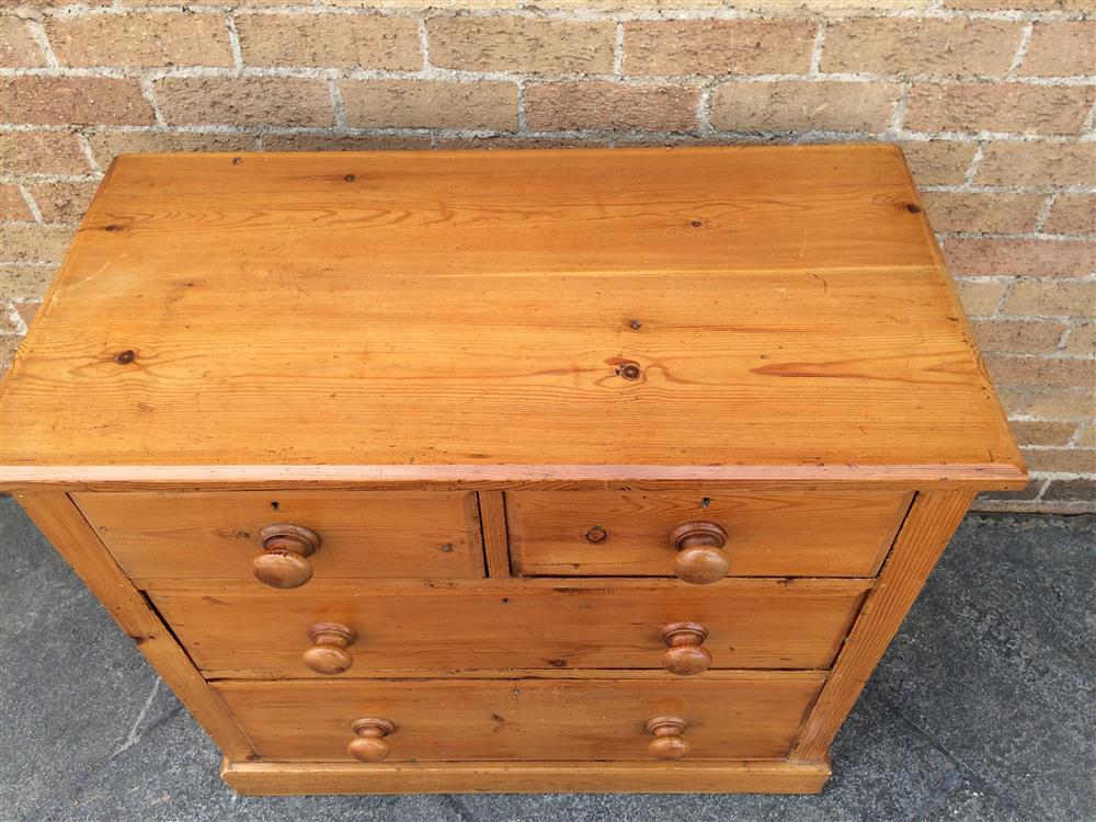 A PINE CHEST  of two short and two long graduated drawers with turned wooden handles and on plinth - Image 2 of 3