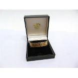 A 9CT GOLD BRACELET of wide flat diamond cut brick links, hidden box clasp with a safety catch, 18cm