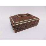 AN ANGLO-INDIAN WORKBOX with carved decoration and a fitted interior, 14cm high, 29.5cm wide, 21cm