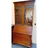 AN EDWARDIAN MAHOGANY BUREAU BOOKCASE with fitted interior, the base with three long drawers, 99cm