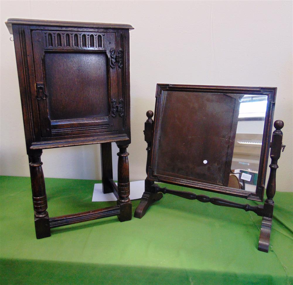 AN OAK POT CUPBOARD WITH CARVED DECORATION on turned supports with stretchers 41cm wide 35cm deep