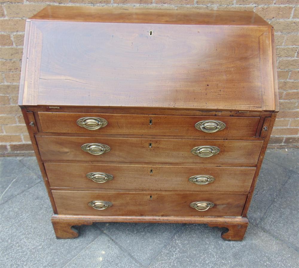 A GEORGE III MAHOGANY BUREAU with fitted interior, four graduated drawers on bracket feet, 102cm