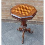 A VICTORIAN ROSEWOOD GAMES/WORK TABLE the octagonal top inlaid with chess board, opening to reveal
