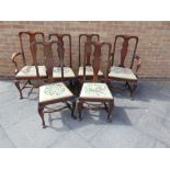 A SET OF SIX OAK DINING CHAIRS including matching pair of carvers, with shaped splats, needlework