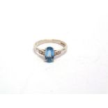 AN AQUAMARINE AND DIAMOND 18 CARAT WHITE GOLD RING the long oval cut measuring approximately 8.6