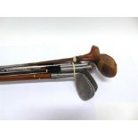 EIGHT ASSORTED GOLF CLUBS including three with simulated hickory shafts.