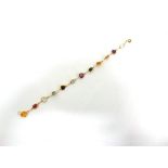 A TWELVE STONE MULTIGEM BRACELET the spectacle set stones include amethyst, citrine, garnet and