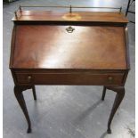 AN EDWARDIAN MAHOGANY LADIES WRITING BUREAU with brass gallery, fitted interior and single drawer,