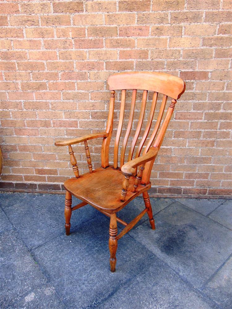 AN ELM AND BEECH WINDSOR ARMCHAIR on turned supports with H-shaped stretcher, 113cm high, the elm