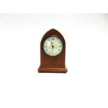 LIBERTY & CO: AN EDWARDIAN MANTLE CLOCK, in lancet shaped mahogany case with line inlaid decoration,