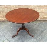 A VICTORIAN MAHOGANY TILT TOP TABLE the circular top 90cm diameter, on tripod base with vase