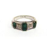 AN EMERALD AND DIAMOND RING the three graduated step cuts with diamonds in between, the white