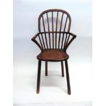 A CHILDS BOW BACK WINDSOR ARMCHAIR of ash and elm construction on four splayed legs, 88cm high,