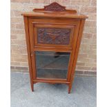 AN EDWARDIAN WALNUT MUSIC CABINET with carved decoration, on square tapering supports 55cm wide,