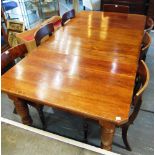 A VICTORIAN WALNUT EXTENDING DINING TABLE on turned and fluted supports, with two additional leaves,