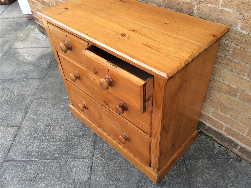 A PINE CHEST  of two short and two long graduated drawers with turned wooden handles and on plinth - Image 3 of 3