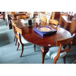 A MAHOGANY EXTENDING DINING TABLE on cabriole supports, with four additional leaves and winder,