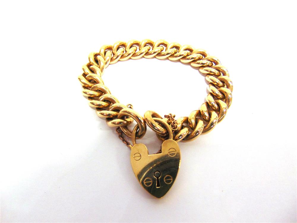 A 9CT GOLD BRACELET  of solid curb links, to a padlock clasp, 77g gross