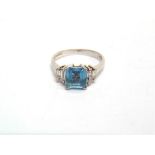 AN AQUAMARINE AND DIAMOND 18CT WHITE GOLD RING the square cut stone, 6.8 by 6.7 by 3.9mm deep,