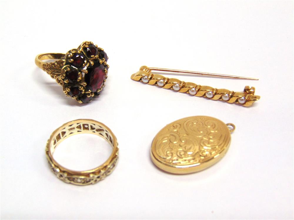 A 9CT GOLD GARNET CLUSTER RING finger size O, a 9ct gold oval locket; a 9ct gold seven stone