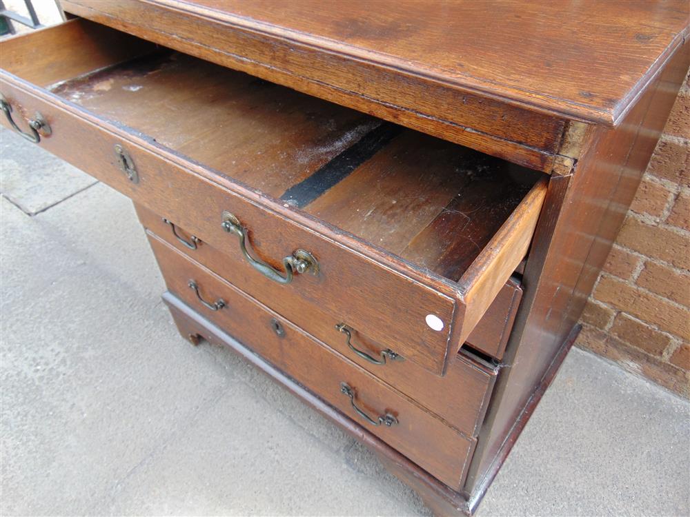 A SMALL OAK CHEST fitted with four long graduated drawers, 76.5cm wide 47cm deep 80.5cm high - Image 3 of 3