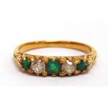 AN EMERALD AND DIAMOND FIVE STONE RING the two old cut diamonds totalling approximately 0.24cts, the