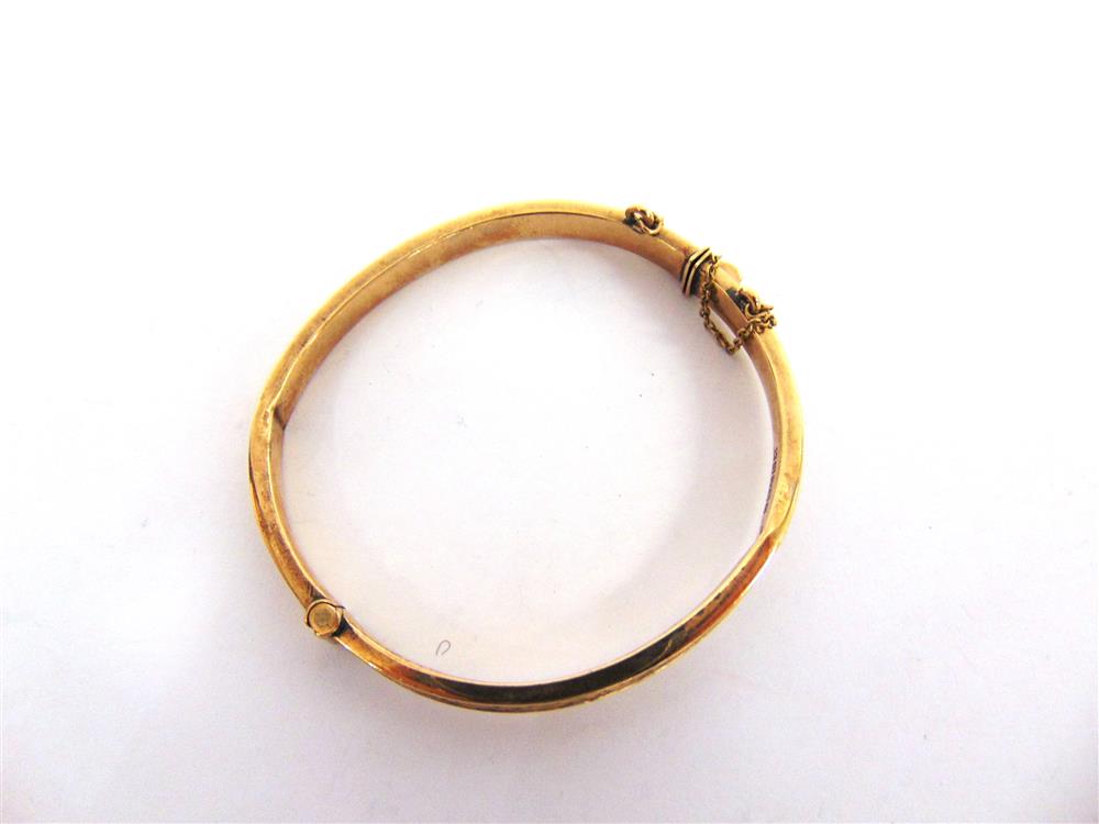 A 9CT GOLD HINGED BANGLE half engraved decoration, 4.7cm inner diameter, 8.9g gross