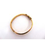 A 9CT GOLD HINGED BANGLE half engraved decoration, 4.7cm inner diameter, 8.9g gross