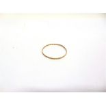 A 9 CARAT GOLD BANGLE of plaited design, 3mm wide, 6.4cm internal diameter, 7.3g gross