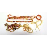 AN AMBER BEAD NECKLACE of graduated beads; with an amber bead bracelet; 48g gross; hardstone