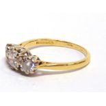 A THREE STONE DIAMOND 18 CARAT GOLD RING the graduated brilliant cuts totalling approximately 1.25