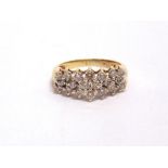 A TWENTY STONE DIAMOND RING stamped 10K, the brilliant cuts totalling approximately 0.8 carats,