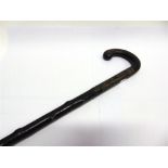 A 19TH CENTURY SWORD STICK the blade with engraved foliate decoration, with a hardwood handle and