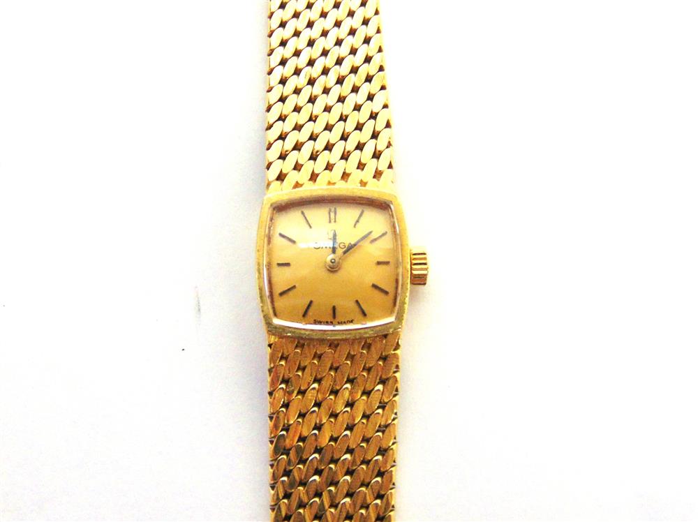 OMEGA a lady's 18 carat bracelet watch, the gilt cushion shaped dial with black hands and batons,