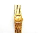 OMEGA a lady's 18 carat bracelet watch, the gilt cushion shaped dial with black hands and batons,