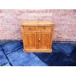 A STRIPPED PINE CUPBOARD,  fitted with two drawers over cupboard, 85cm wide 47cm deep 84cm high