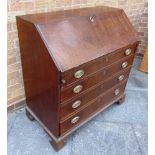 A GEORGE III OAK BUREAU  with fitted interior over four long drawers on bracket feet, 102cm wide