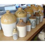 ELEVEN ASSORTED STONEWARE JARS & BOTTLES including those for 'Taylor / Wine & Spirit Merchant /