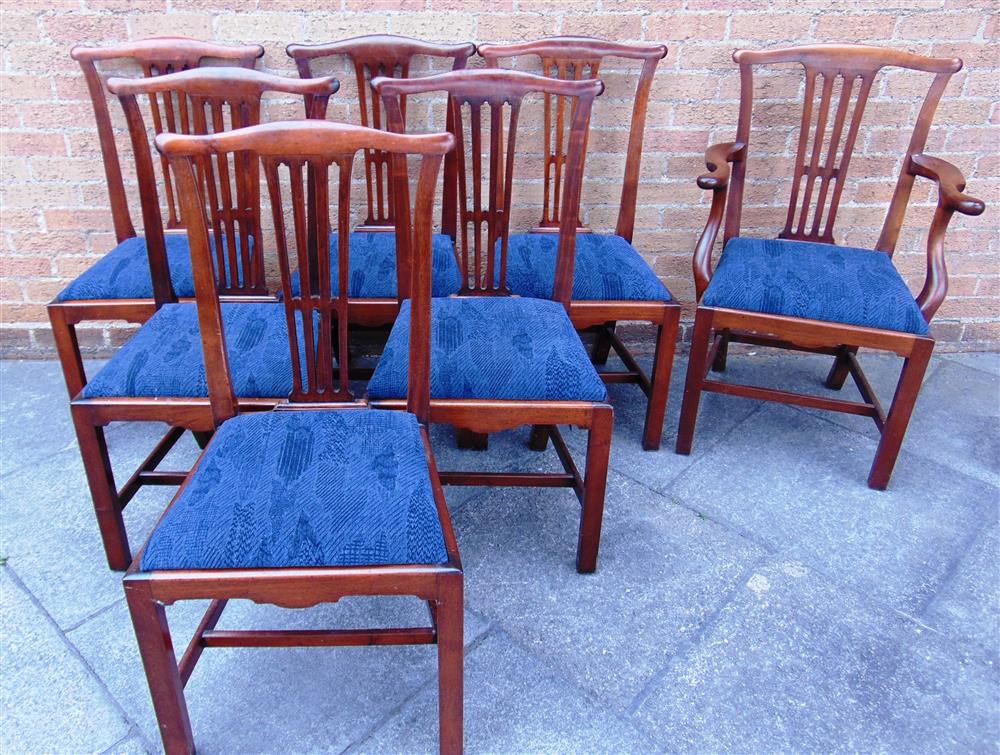 A SET OF SEVEN MAHOGANY DINING CHAIRS  including a carver, with pierced vase shaped splats on square